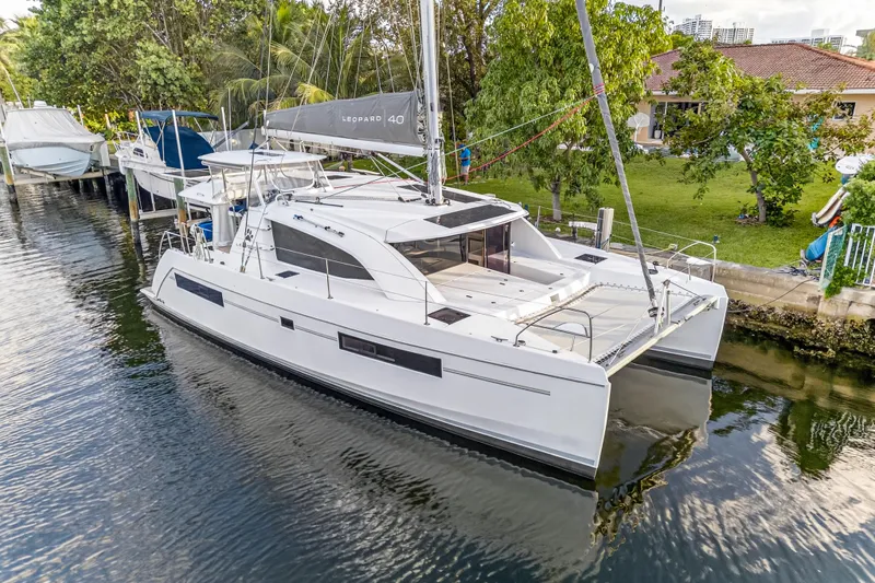 Changing Keys Yacht Photos Pics 2020 Leopard 40 catamaran docked in a serene canal setting.