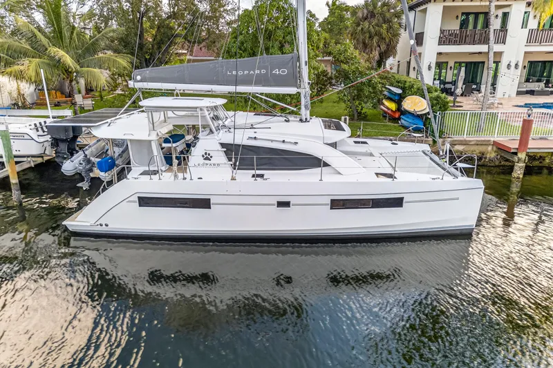 Changing Keys Yacht Photos Pics 2020 Leopard 40 catamaran docked by waterfront property, featuring sleek design and modern amenities.