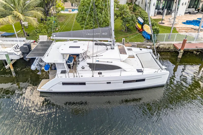 Changing Keys Yacht Photos Pics Aerial view of 2020 Leopard 40 catamaran docked by waterfront property.