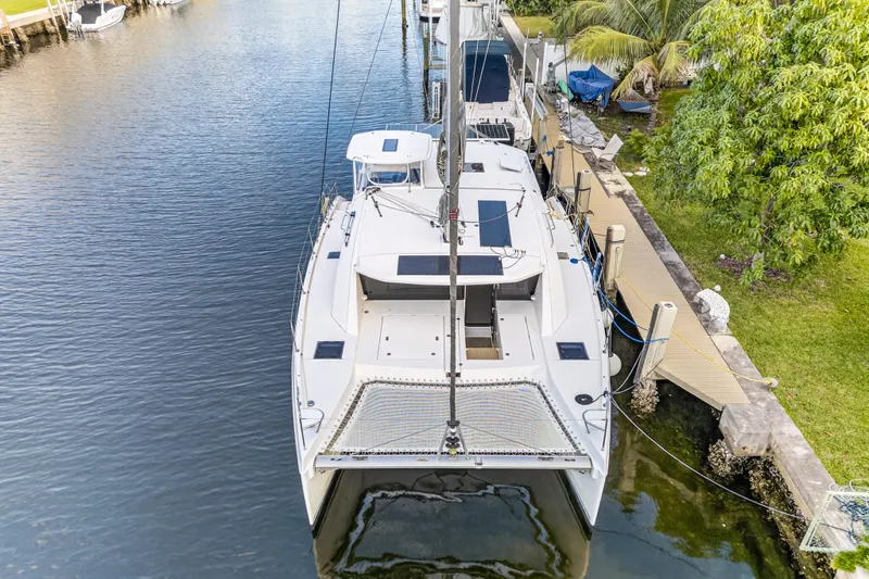 Changing Keys Yacht Photos Pics 2020 Leopard 40 catamaran docked in a serene canal setting.