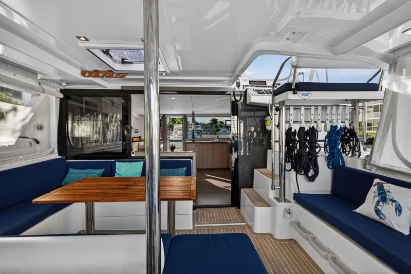 Changing Keys Yacht Photos Pics Luxurious 2020 Leopard 40 catamaran interior with blue seating and wooden table.