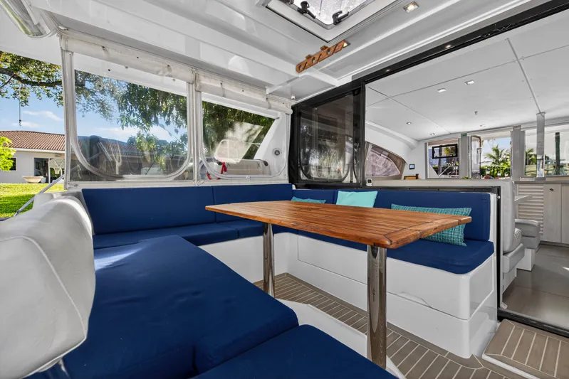 Changing Keys Yacht Photos Pics Spacious interior of 2020 Leopard 40 catamaran with blue seating and wooden table.