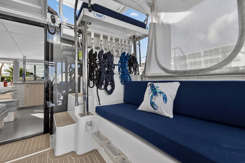 Changing Keys Yacht Photos Pics 2020 Leopard 40 yacht interior with blue seating, lobster pillow, and nautical ropes.