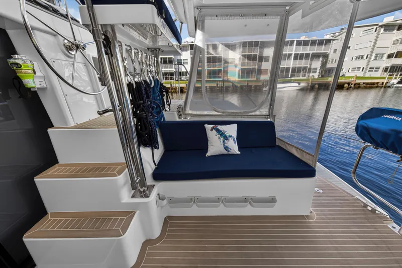 Changing Keys Yacht Photos Pics 2020 Leopard 40 yacht interior with blue seating, nautical decor, and marina view.