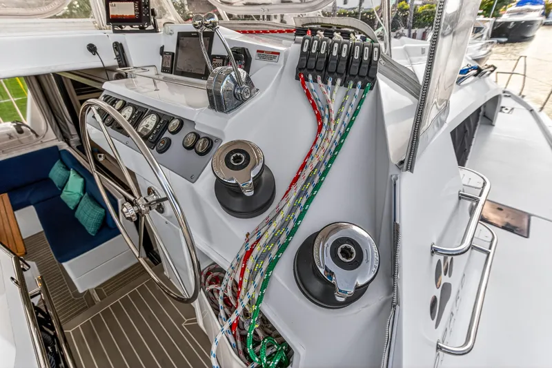 Changing Keys Yacht Photos Pics Helm of 2020 Leopard 40 catamaran with steering wheel, control panel, and colorful ropes.