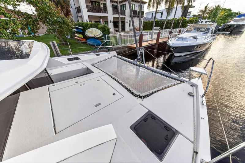 Changing Keys Yacht Photos Pics 2020 Leopard 40 catamaran docked near waterfront homes and boats.