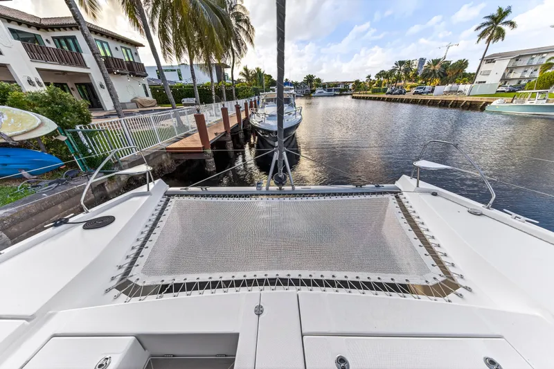 Changing Keys Yacht Photos Pics Front view of a 2020 Leopard 40 catamaran docked in a scenic canal.