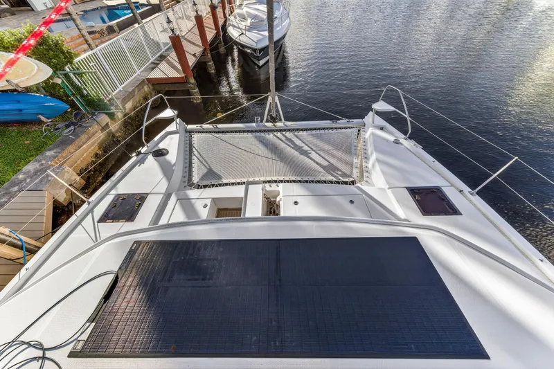Changing Keys Yacht Photos Pics 2020 Leopard 40 catamaran docked, featuring spacious deck and netting over water.