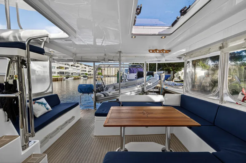 Changing Keys Yacht Photos Pics Spacious interior of 2020 Leopard 40 catamaran with blue seating and wooden table.