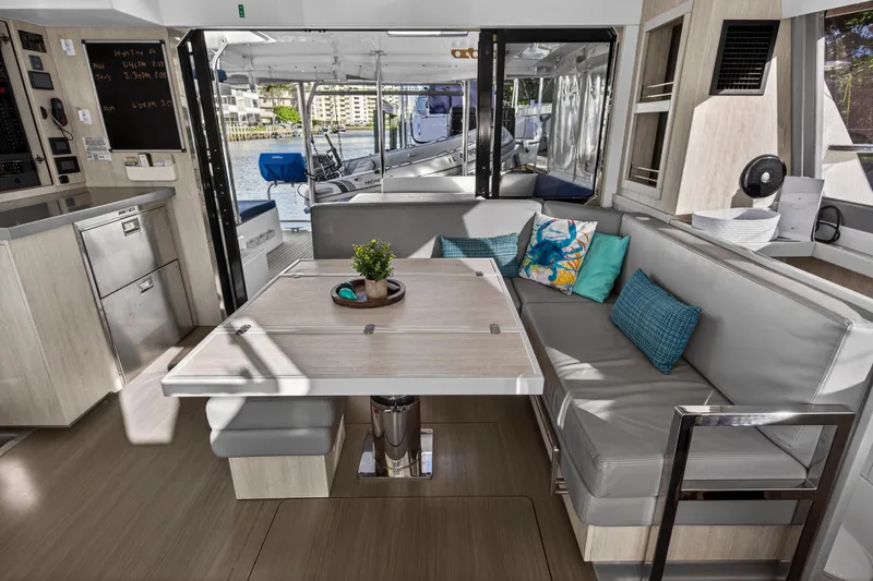 Changing Keys Yacht Photos Pics Modern interior of 2020 Leopard 40 catamaran with cozy seating and dining area.