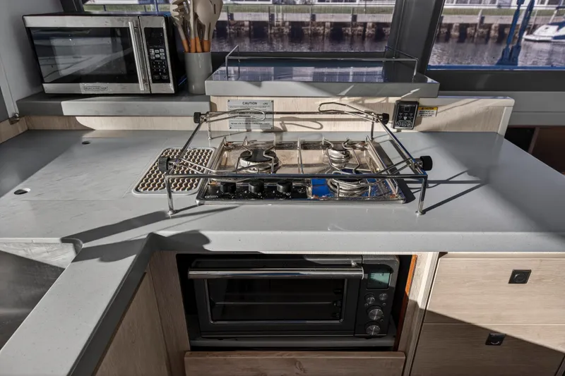 Changing Keys Yacht Photos Pics Modern kitchen in 2020 Leopard 40 yacht with stove, oven, and microwave.