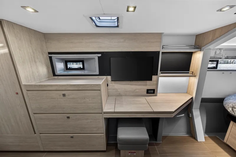 Changing Keys Yacht Photos Pics Modern interior of 2020 Leopard 40 yacht with desk, TV, and storage cabinets.