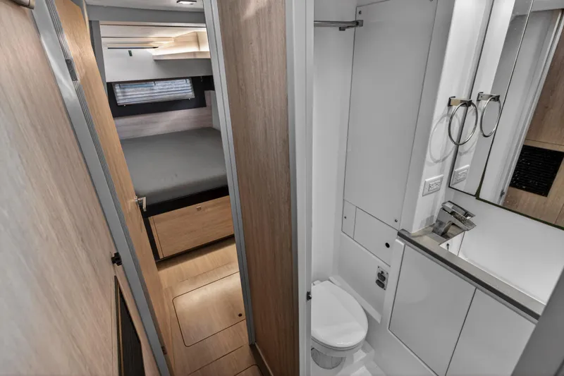 Changing Keys Yacht Photos Pics Modern interior of 2020 Leopard 40 yacht featuring compact bathroom and cozy bedroom.