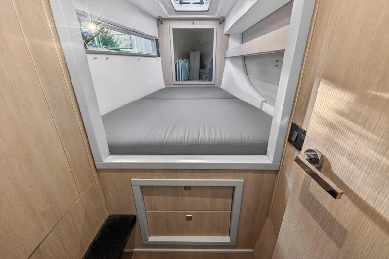 Changing Keys Yacht Photos Pics 2020 Leopard 40 interior cabin with bed, wooden finish, and storage drawers.