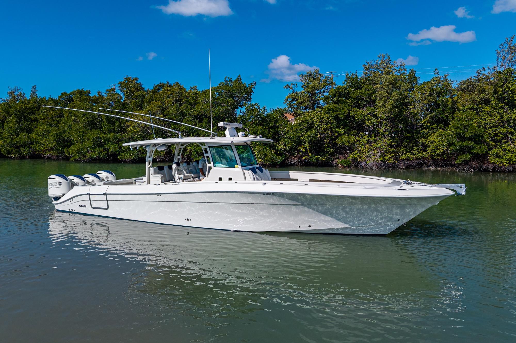 2018 HCB 42 Siesta boat on calm water, surrounded by lush greenery.