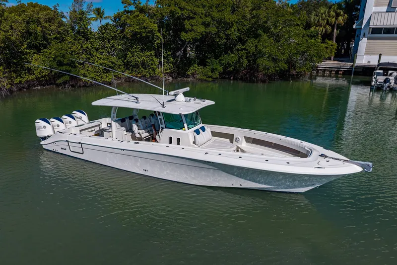  Yacht Photos Pics 2018 HCB 42 Siesta boat on calm water, surrounded by lush greenery.