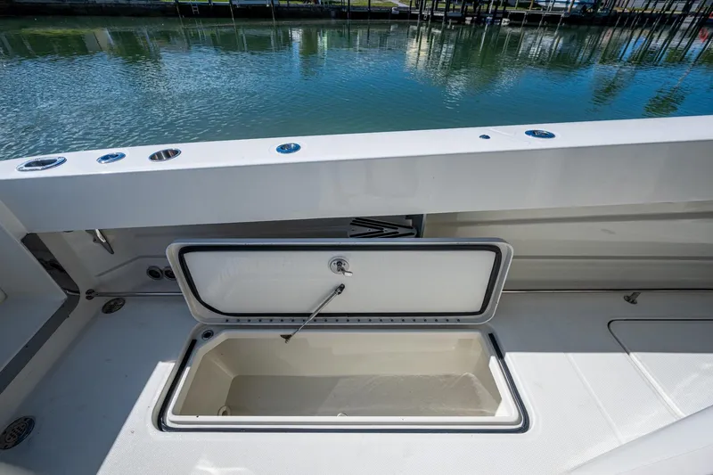  Yacht Photos Pics 2018 HCB 42 Siesta boat with open storage compartment by the water.