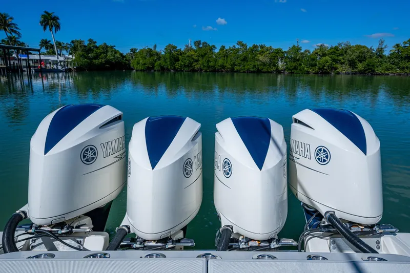  Yacht Photos Pics Four Yamaha outboard engines on a 2018 HCB 42 Siesta boat, with scenic water backdrop.