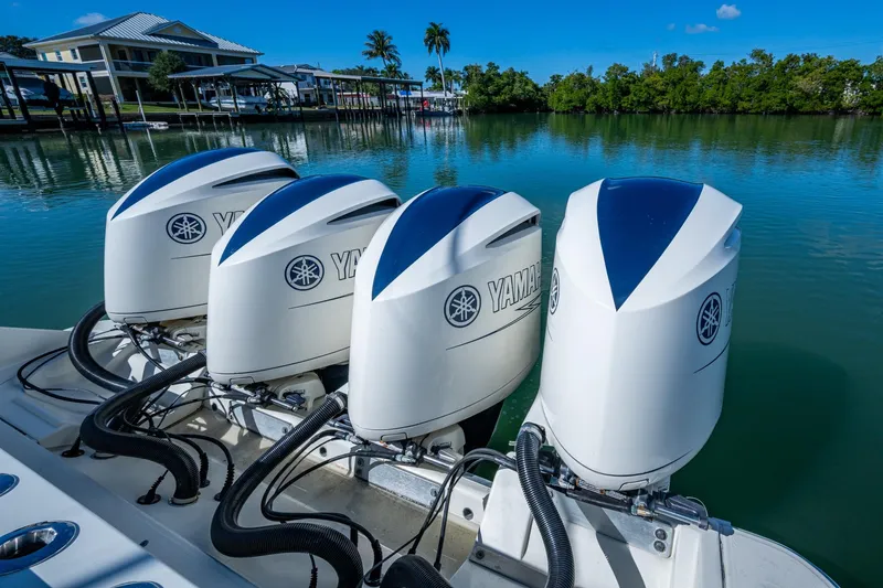  Yacht Photos Pics Four Yamaha outboard engines on a 2018 HCB 42 Siesta boat, docked by waterfront homes.