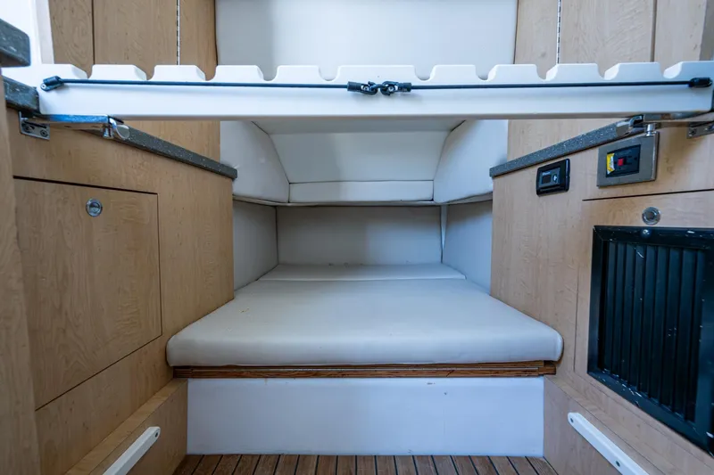  Yacht Photos Pics 2018 HCB 42 Siesta cabin interior with wooden cabinetry and cushioned seating.