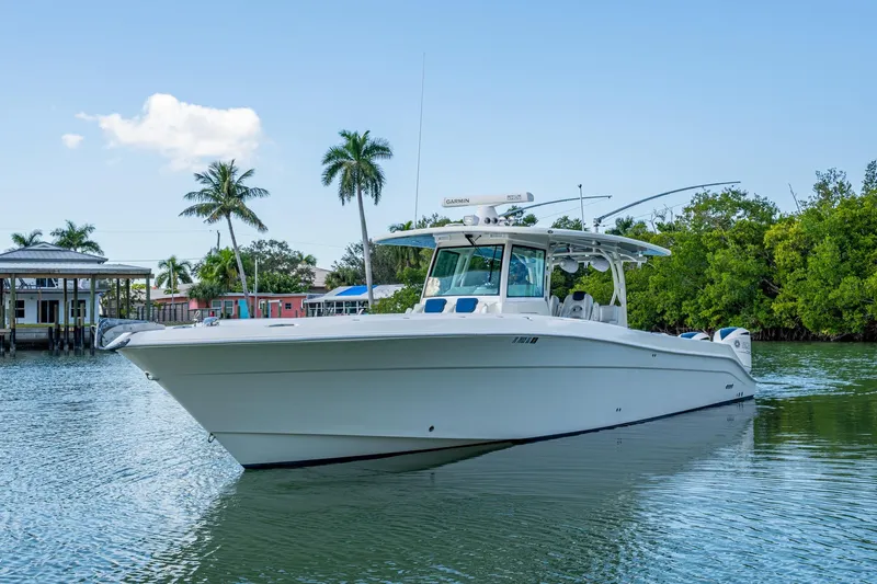 Yacht Photos Pics 2018 HCB 42 Siesta boat on calm water with palm trees in the background.