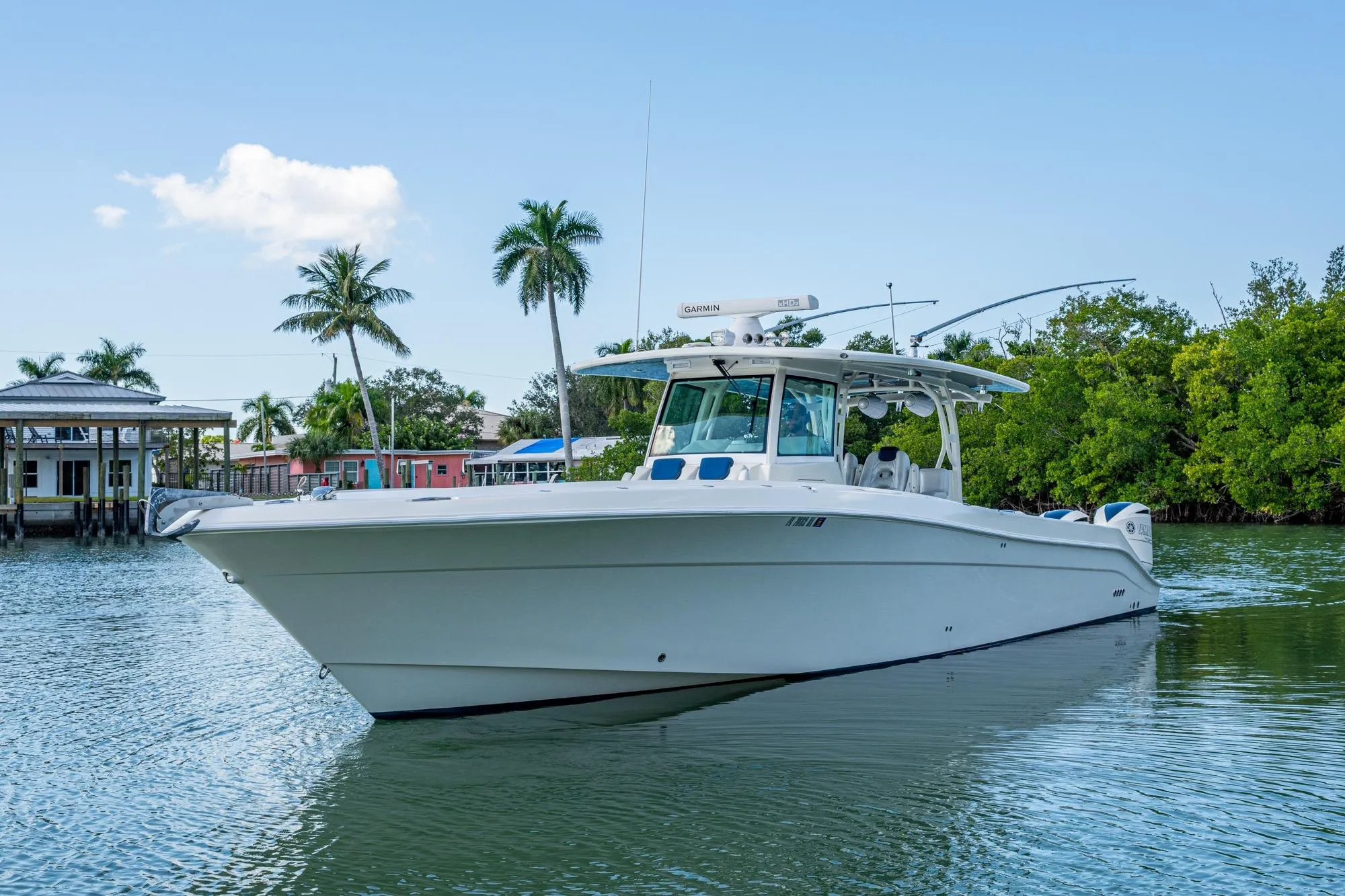 2018 HCB 42 Siesta boat on calm water with palm trees in the background.