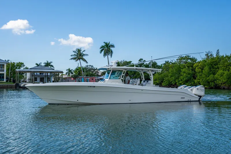 Yacht Photos Pics 2018 HCB 42 Siesta boat cruising on a calm waterway with palm trees in the background.