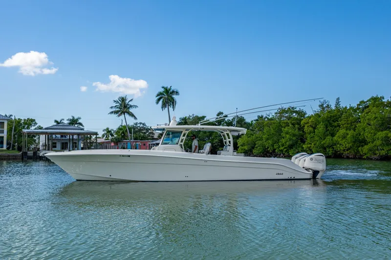  Yacht Photos Pics 2018 HCB 42 Siesta boat on calm water with clear blue sky and palm trees.