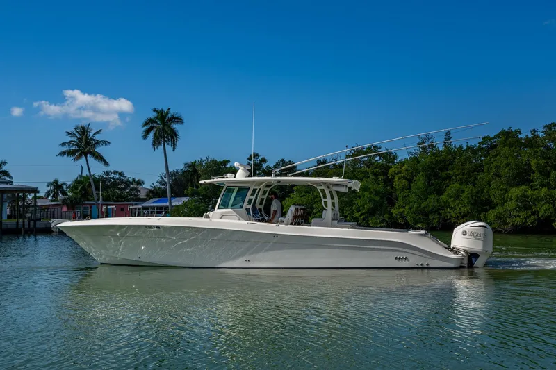  Yacht Photos Pics 2018 HCB 42 Siesta boat cruising on a sunny day with palm trees in the background.