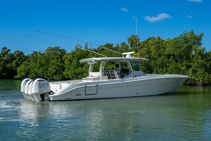  Yacht Photos Pics 2018 HCB 42 Siesta boat cruising on a calm waterway with lush greenery.