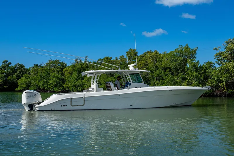  Yacht Photos Pics 2018 HCB 42 Siesta boat cruising on calm water, surrounded by lush greenery.