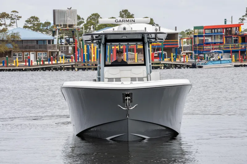  Yacht Photos Pics 2022 Invincible 39 Open Fisherman boat on water, front view, with colorful marina background.