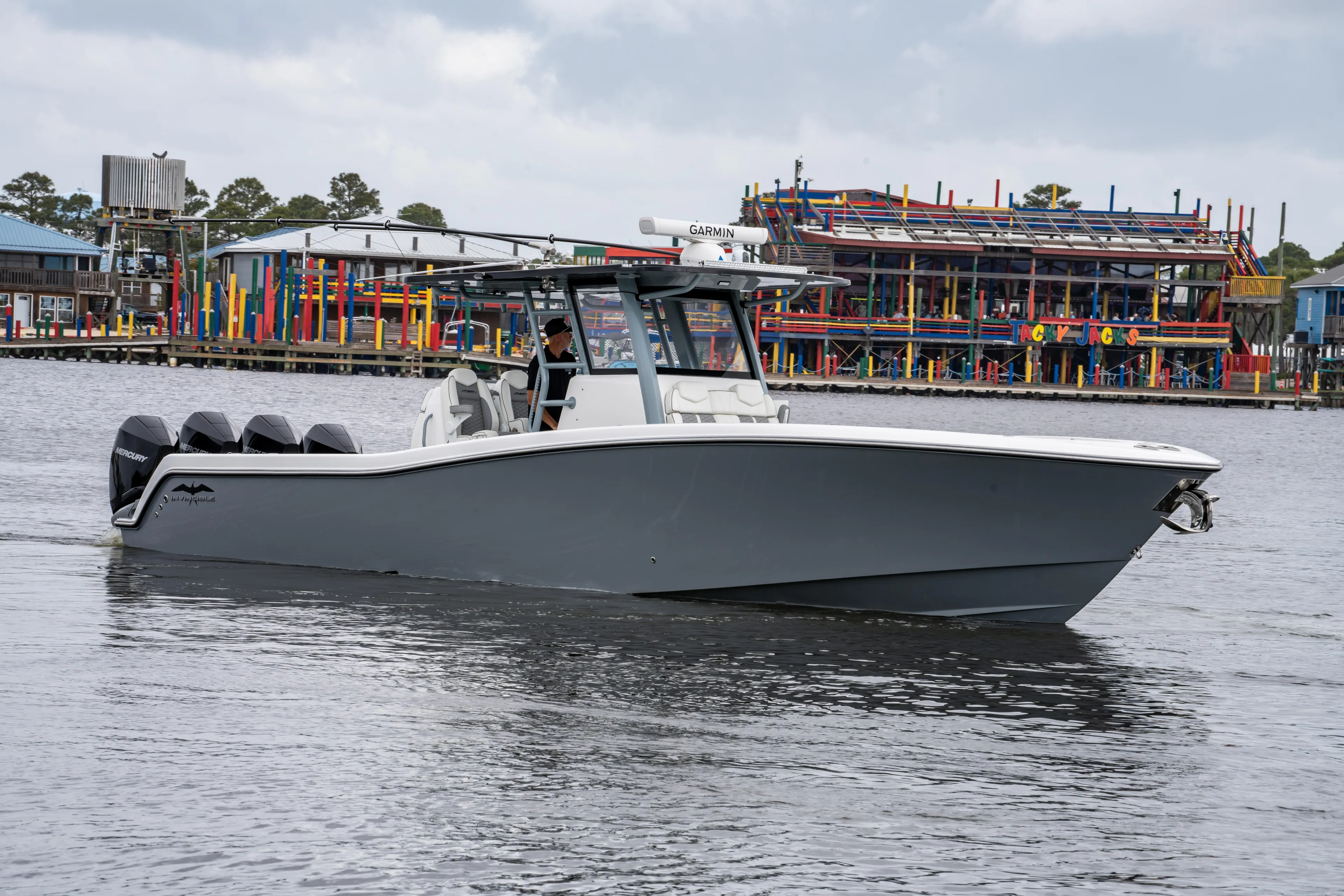  Yacht Photos Pics 2022 Invincible 39 Open Fisherman boat on water near colorful waterfront buildings.