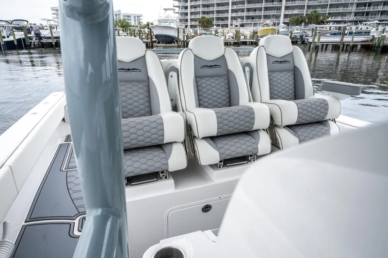  Yacht Photos Pics 2022 Invincible 39 Open Fisherman boat with three cushioned seats at a marina.