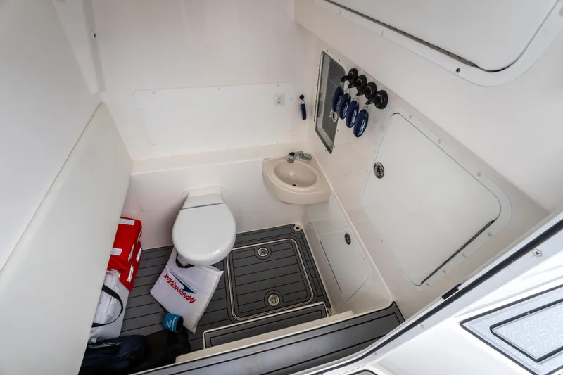  Yacht Photos Pics 2022 Invincible 39 Open Fisherman boat bathroom with toilet and sink.