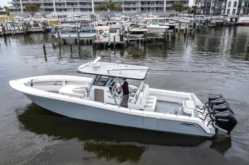  Yacht Photos Pics 2022 Invincible 39 Open Fisherman boat docked in marina, featuring triple Mercury engines.