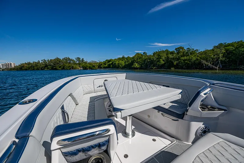  Yacht Photos Pics 2023 Nor-Tech 400 boat interior with seating and table on a sunny day.