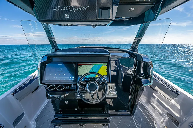  Yacht Photos Pics 2023 Nor-Tech 400 boat cockpit with advanced navigation system on open water.