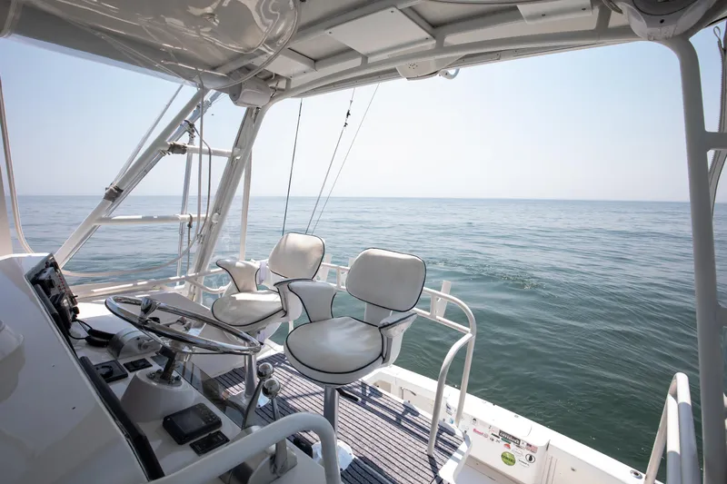  Yacht Photos Pics Flybridge view of 2003 Jupiter 35 boat overlooking calm ocean waters.