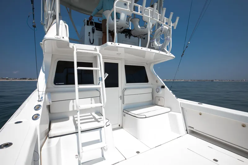  Yacht Photos Pics 2003 Jupiter 35 Flybridge boat with ladder and seating on deck.