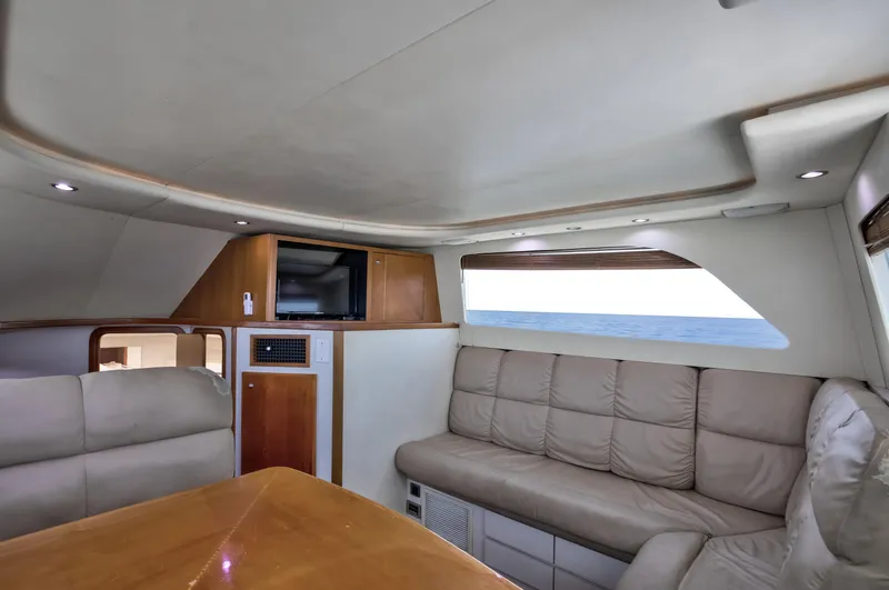  Yacht Photos Pics Luxurious interior of 2003 Jupiter 35 Flybridge yacht with plush seating and ocean view.