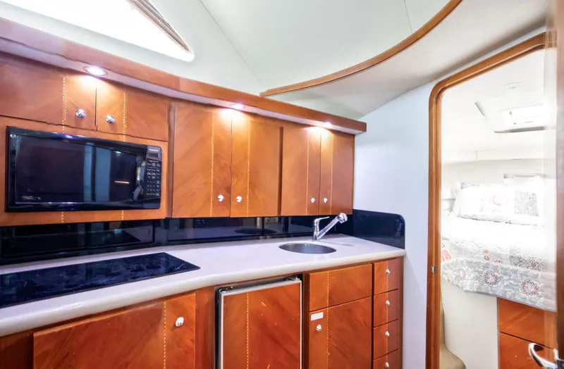  Yacht Photos Pics Luxurious 2003 Jupiter 35 Flybridge yacht kitchen with wood cabinets and modern appliances.