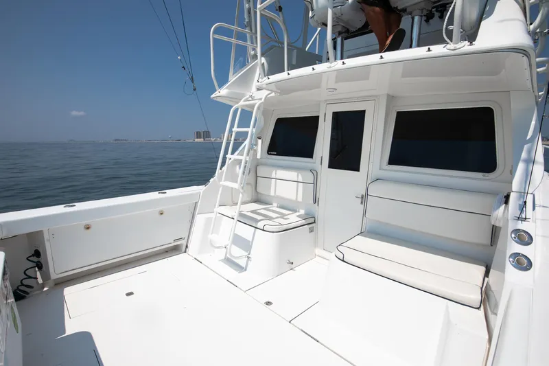  Yacht Photos Pics 2003 Jupiter 35 Flybridge boat deck with seating and ladder, ocean view.