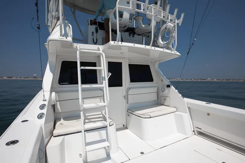  Yacht Photos Pics 2003 Jupiter 35 Flybridge boat with ladder and seating on deck.