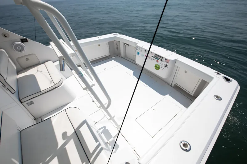  Yacht Photos Pics 2003 Jupiter 35 Flybridge boat deck with seating, overlooking calm ocean waters.