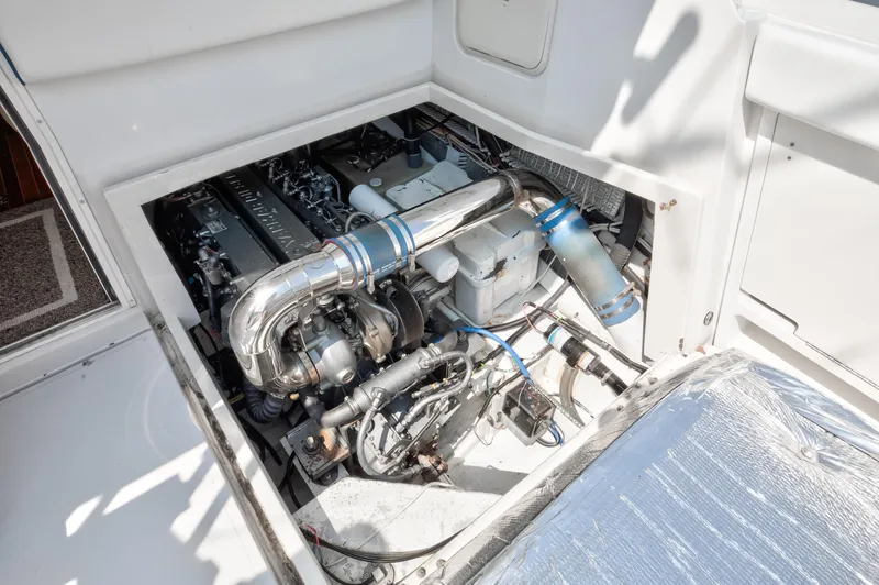  Yacht Photos Pics Engine compartment of 2003 Jupiter 35 Flybridge boat, showcasing mechanical components.