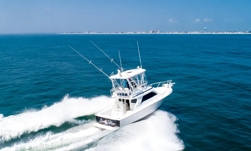  Yacht Photos Pics Jupiter 35 Flybridge 2003 cruising on open blue ocean under clear sky.
