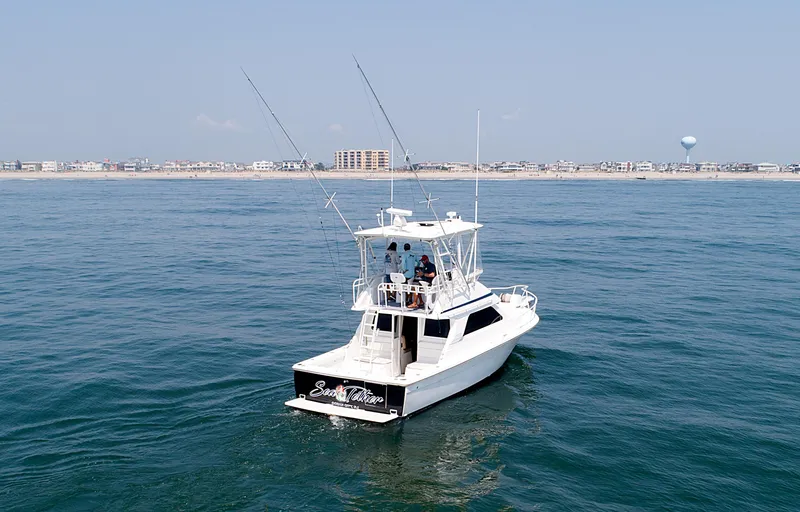  Yacht Photos Pics Jupiter 35 Flybridge 2003 boat on open water near coastline.