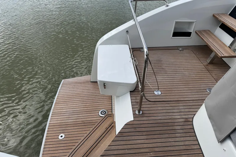 Yacht Photos Pics Teak deck of 2026 Lagoon 55 yacht with stainless steel railing and water view.