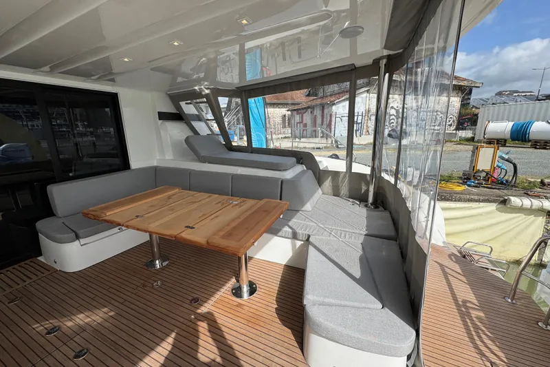  Yacht Photos Pics Luxurious 2026 Lagoon 55 yacht interior with elegant seating and wooden table.